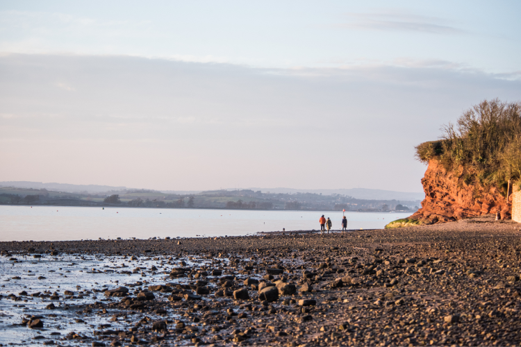 Low tide at Exe Estuary People walking across Exe estuary beach towards horizon
